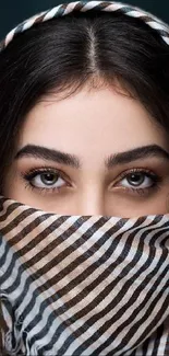 Portrait of woman with striped headscarf and expressive eyes.