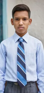 Young man in a blue striped shirt and tie.