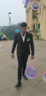 Man in suit walking with bubbles in front of a classical building backdrop.