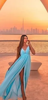 Woman in blue dress at sunset with city backdrop.