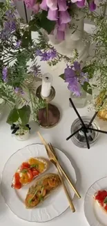 Elegant table setting with flowers and gourmet dishes.