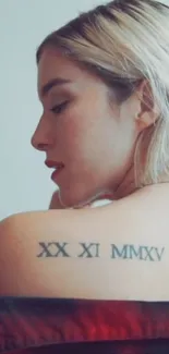 Woman with shoulder tattoo turned profile view.