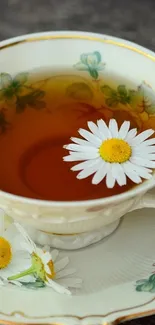 Elegant tea cup with chamomile flower and floral design.