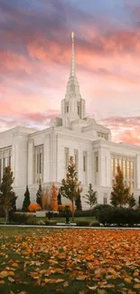 Elegant temple at sunset with autumn leaves and a vibrant sky.