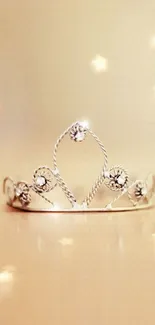 Elegant tiara with sparkling jewels on a gold background.