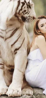 Elegant wallpaper of a white tiger sitting beside a serene woman.