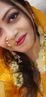 Woman in traditional Indian attire with gold accents.