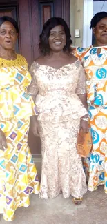 Three women in elegant traditional attire, showcasing vibrant patterns.