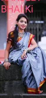 Woman in traditional saree sitting elegantly with a scenic background.