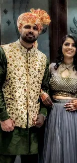 Couple in elegant traditional attire with vibrant colors.