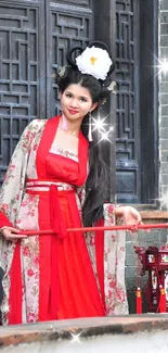 Woman in traditional red dress by a wooden door.