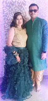 Elegant couple in green and gold traditional attire, standing indoors.