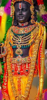 Vividly adorned traditional deity statue in bright colors and intricate jewelry.