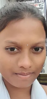 A close-up portrait of a person with traditional earrings, showing cultural elegance.