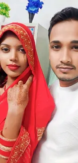 Couple in traditional Indian attire with vibrant red saree.