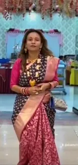 Woman in elegant pink traditional saree indoors.