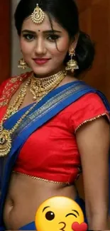 Woman in vibrant traditional red saree with gold jewelry.