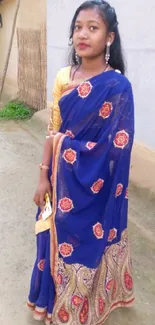 Woman in vibrant blue traditional saree.