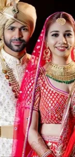 Couple in traditional wedding attire with vibrant colors.