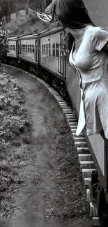 Woman on a train gazing out in black and white.