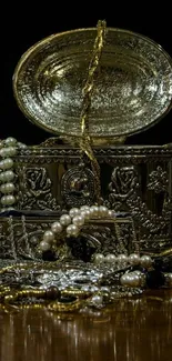 Luxurious treasure chest with pearls and gold chains on wooden table.