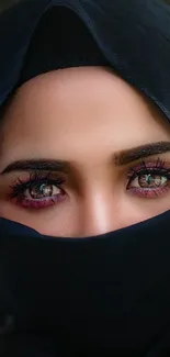 Veiled woman portrait with striking eyes and a dark veil.