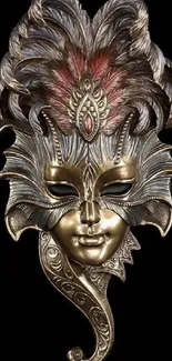 Elegant Venetian mask with gold and feathers on black background.