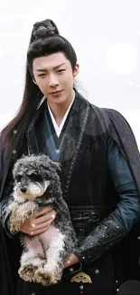 An elegant warrior in dark clothes holding a puppy by the beach.