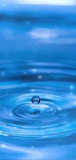 Blue water droplet with ripples in a serene background.