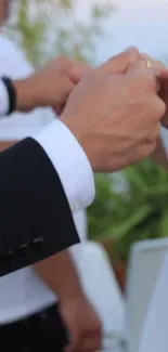 Elegant wedding couple holding hands during a dance.