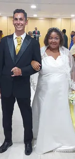 Smiling bride and groom posing at their elegant wedding.