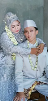 Elegant wedding couple in traditional attire with soft gray tones.