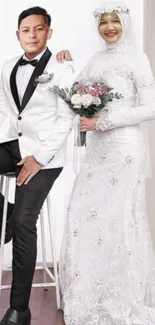 Wedding couple portrait with bride in white gown and groom in tuxedo.