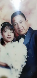 Elegant wedding couple portrait with floral bouquet.