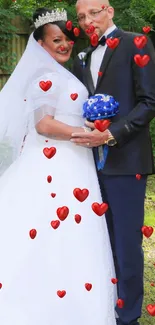 Elegant couple in wedding attire in a lush garden setting.