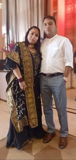 Elegant couple in traditional attire at a wedding celebration.