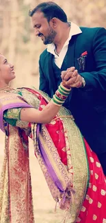 Elegant couple dancing in traditional wedding attire outdoors.