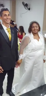 Wedding couple in formal attire, bride in white dress with veil.