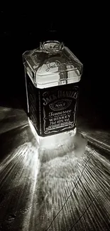 Black and white whiskey bottle with glowing reflections.