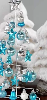 White Christmas tree with blue ornaments and snowy background.