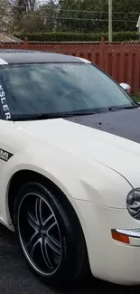 Chrysler Hemi car with rain-dappled surface in a driveway.