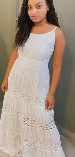 Woman in an elegant white dress posing for a mobile wallpaper.