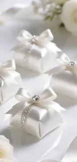 Elegant white gift boxes with ribbons and flowers for decorative use.