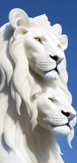 White lion sculpture against blue sky.