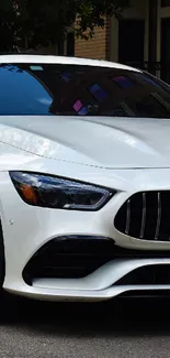 White luxury sports car parked on urban street.