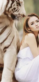 White tiger with woman in elegant pose on a serene backdrop.