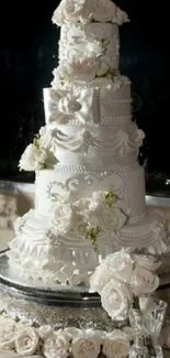 Elegant tiered wedding cake with white floral accents.