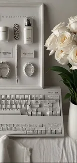 White workspace with roses and keyboard.