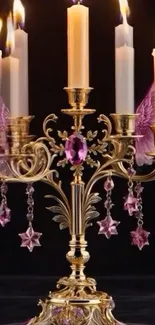 Gold candlestick with pink jewels and wings.