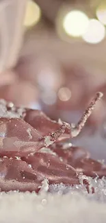 Rose gold candles on a snowy background with bokeh lights.